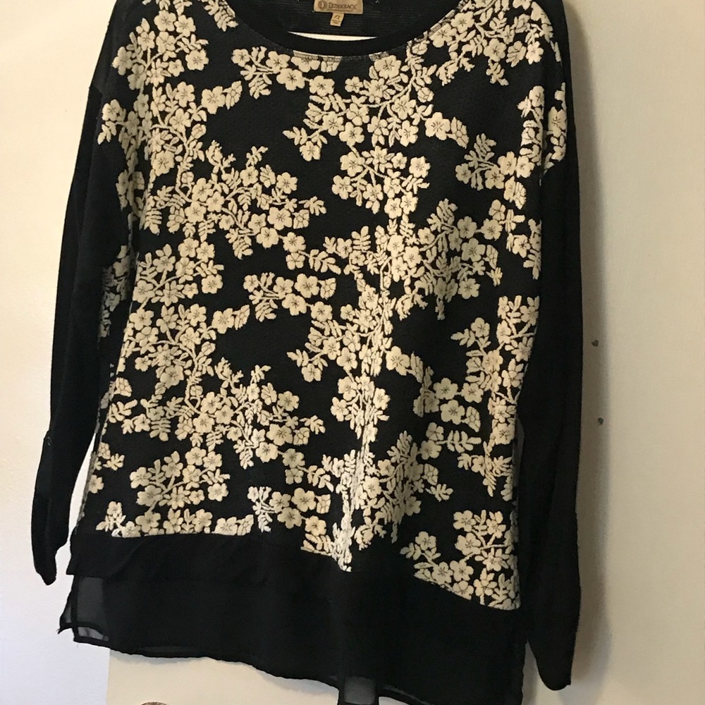 Long sleeve, exquisite, floral fabric blouse.